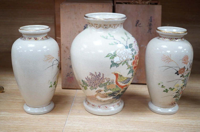 A pair of Satsuma earthenware baluster vases, and one other, larger, each with original wooden boxes, tallest 28cm. Condition - crazed